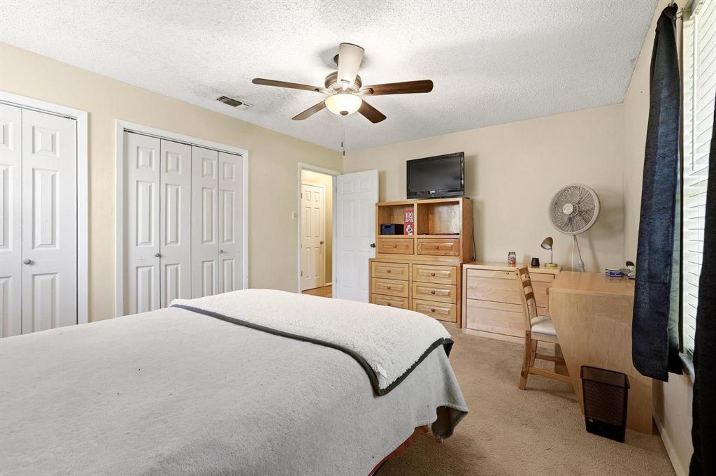 10 Carter Road Van Alstyne, TX 75495 - Photo 3 of 9 a bedroom with a bed and a chandelier