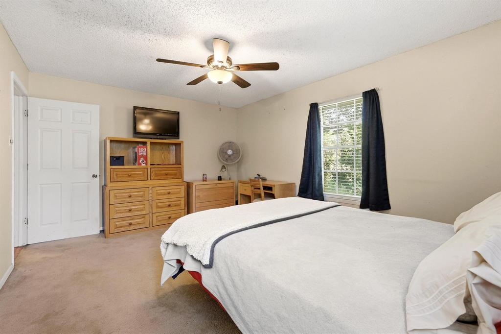 10 Carter Road Van Alstyne, TX 75495 - Photo 4 of 9 a bedroom with a bed a dresser and a chandelier