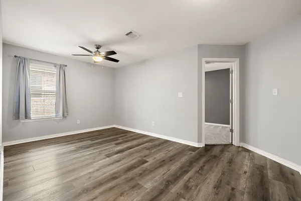 wooden floor in an empty room with a window