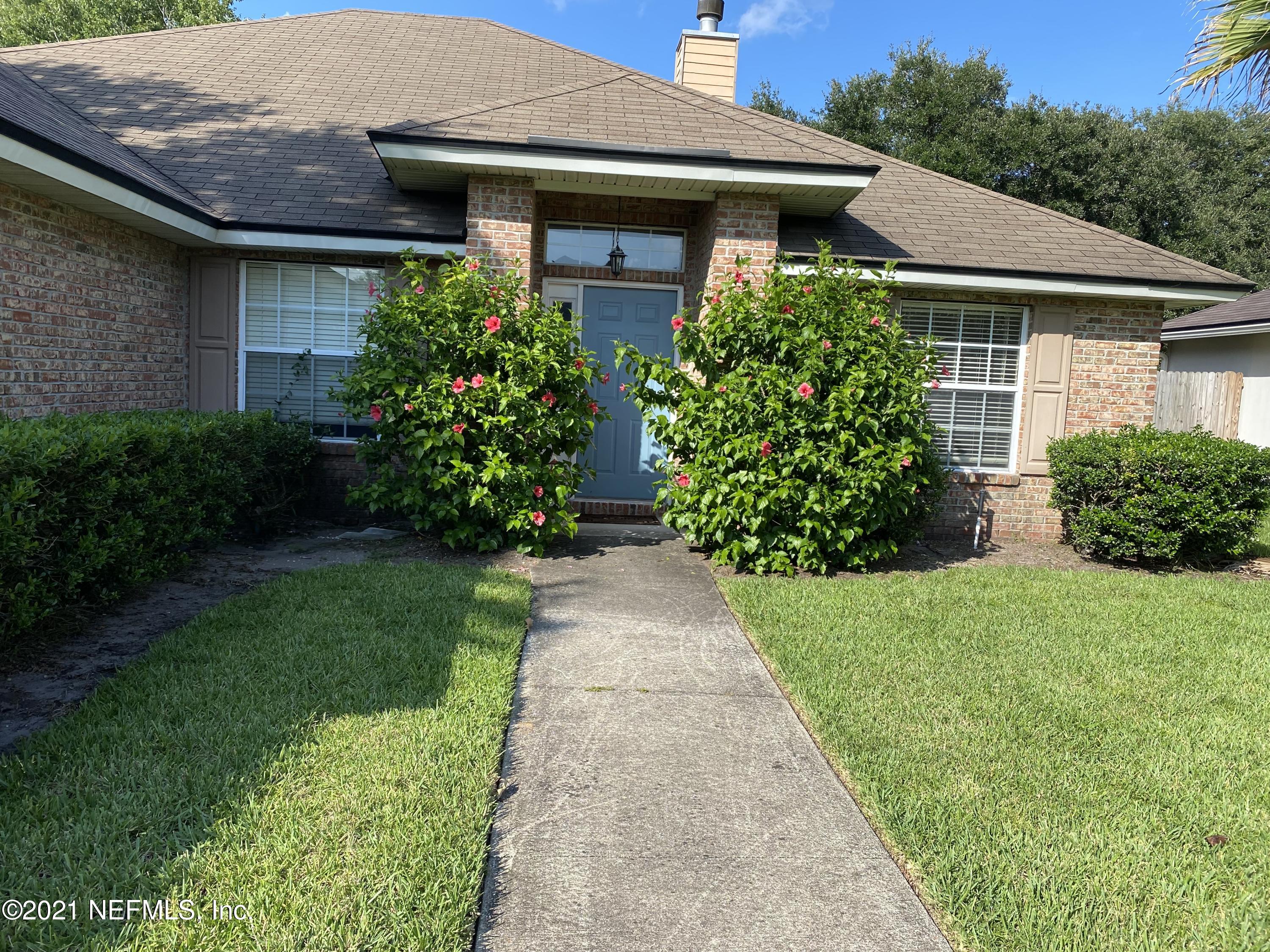 4387 Pebble Brook Drive Jacksonville, FL 32224 - Photo 2 of 30 a front view of a house with garden