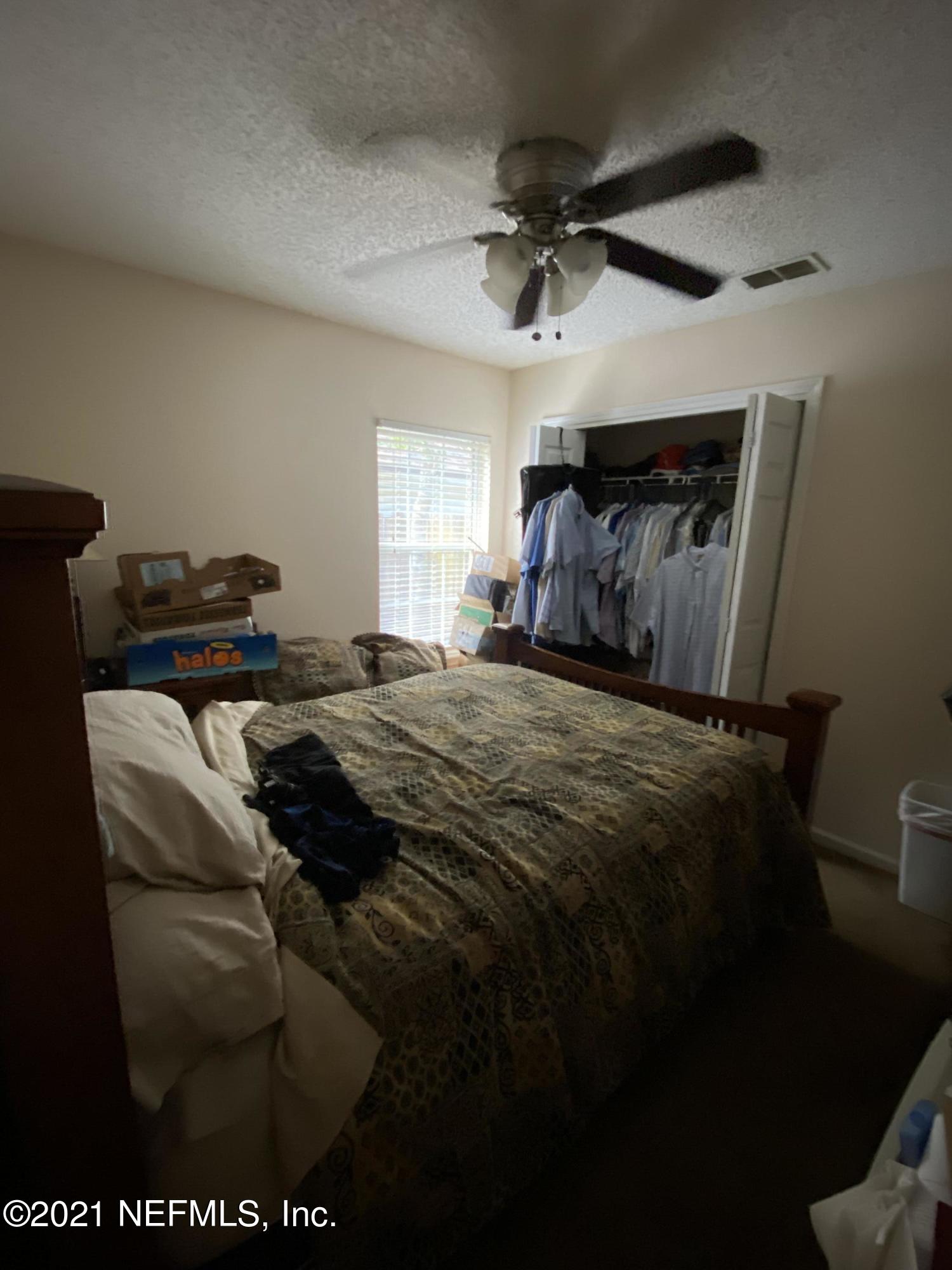 4387 Pebble Brook Drive Jacksonville, FL 32224 - Photo 23 of 30 a bedroom with a bed and a ceiling fan
