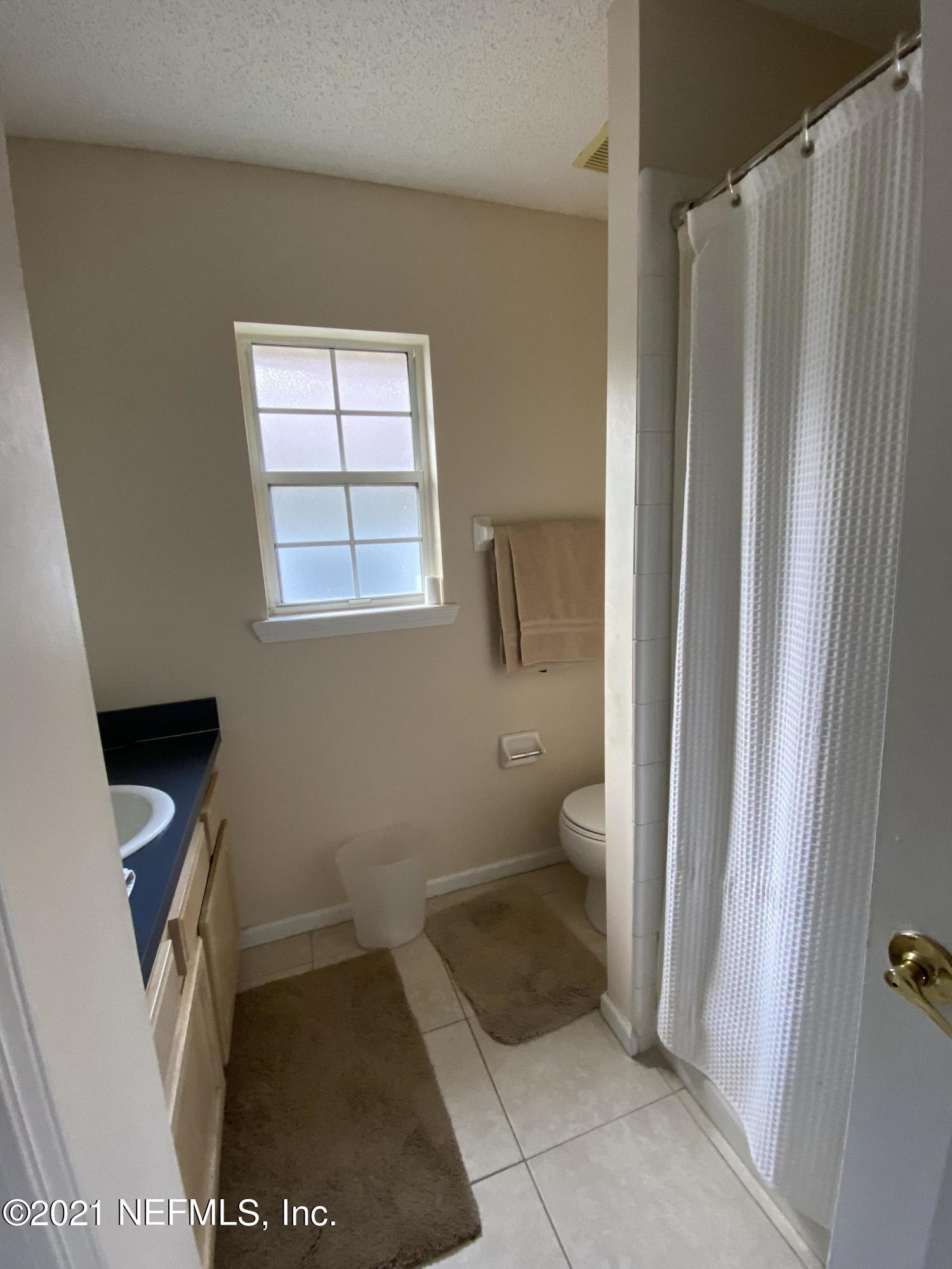 4387 Pebble Brook Drive Jacksonville, FL 32224 - Photo 25 of 30 a bathroom with a toilet and a shower