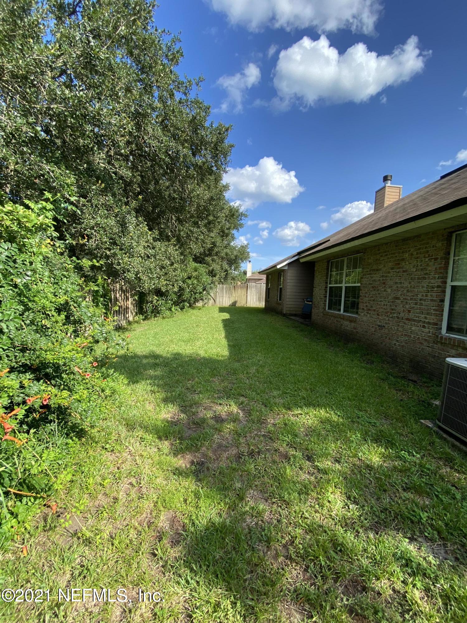 4387 Pebble Brook Drive Jacksonville, FL 32224 - Photo 29 of 30 a view of a house with a yard