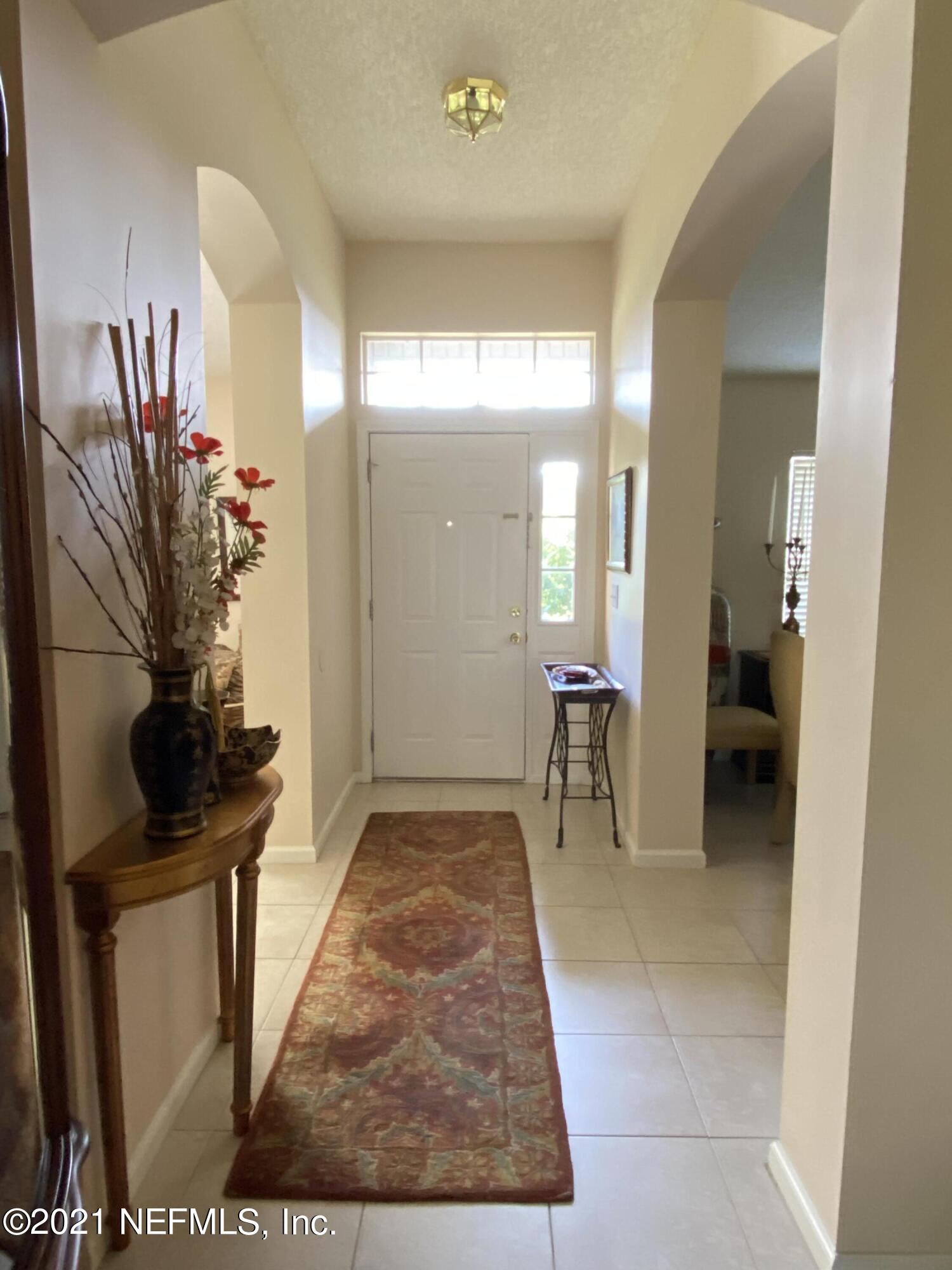 4387 Pebble Brook Drive Jacksonville, FL 32224 - Photo 3 of 30 a view of hallway with furniture and a potted plant