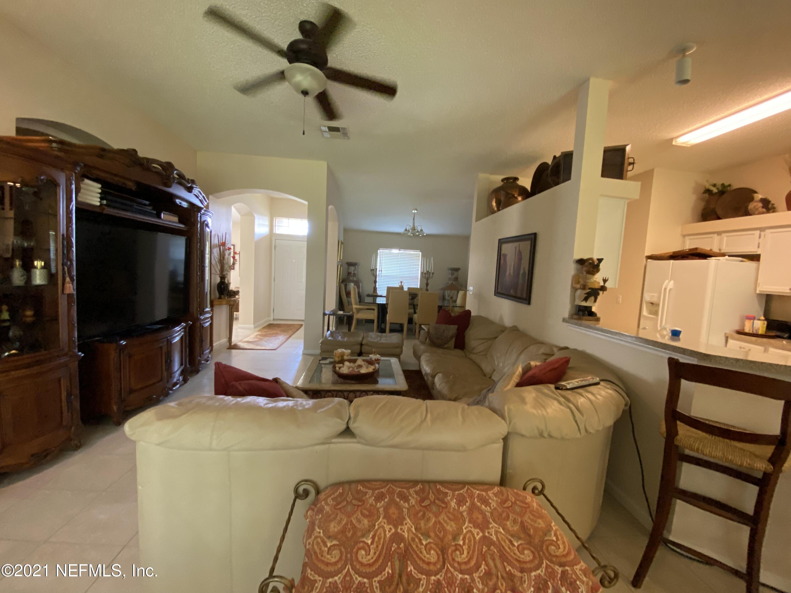 4387 Pebble Brook Drive Jacksonville, FL 32224 - Photo 8 of 30 a living room with furniture and a flat screen tv