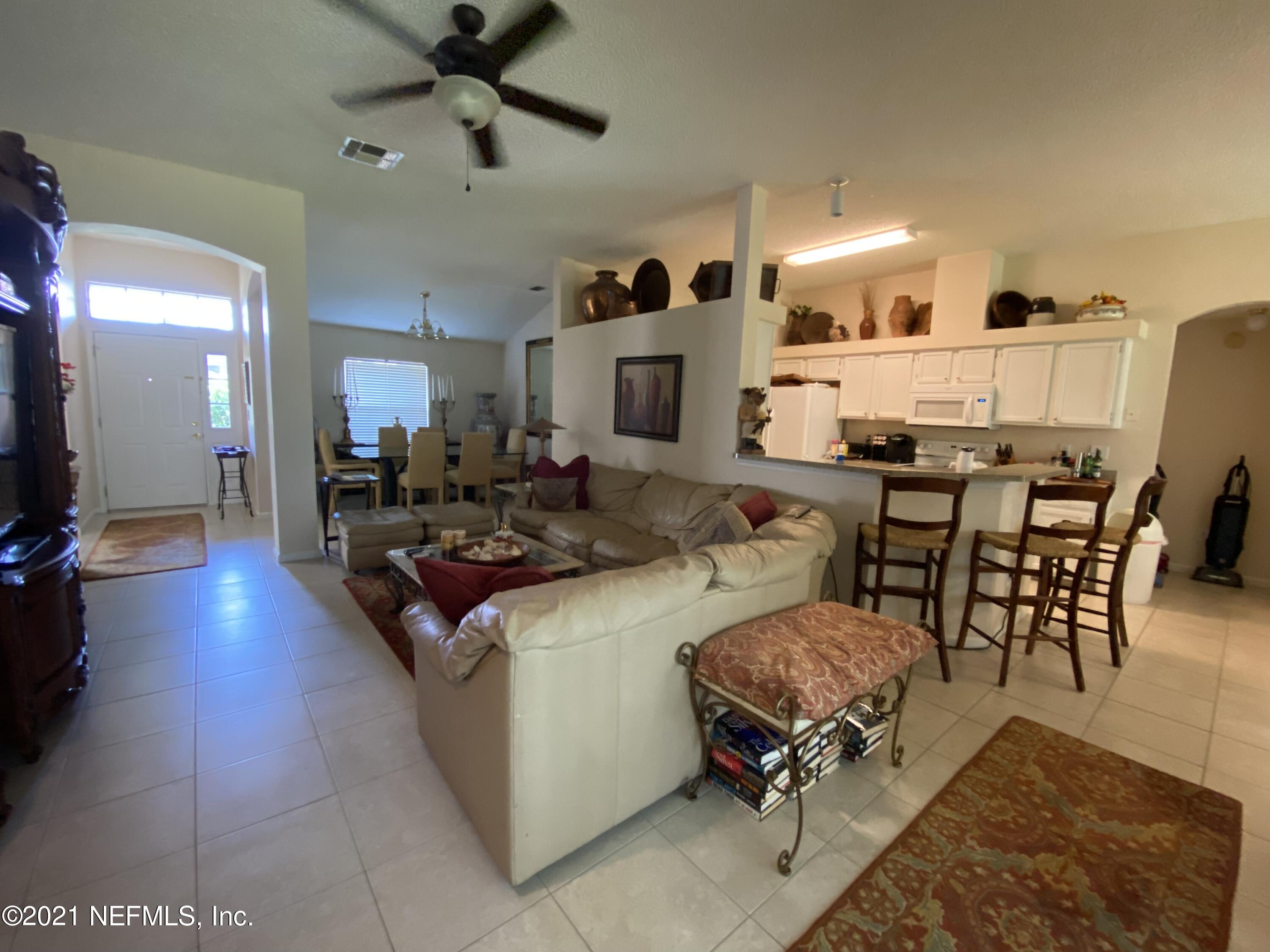 4387 Pebble Brook Drive Jacksonville, FL 32224 - Photo 9 of 30 a living room with stainless steel appliances kitchen island granite countertop furniture and a dining table