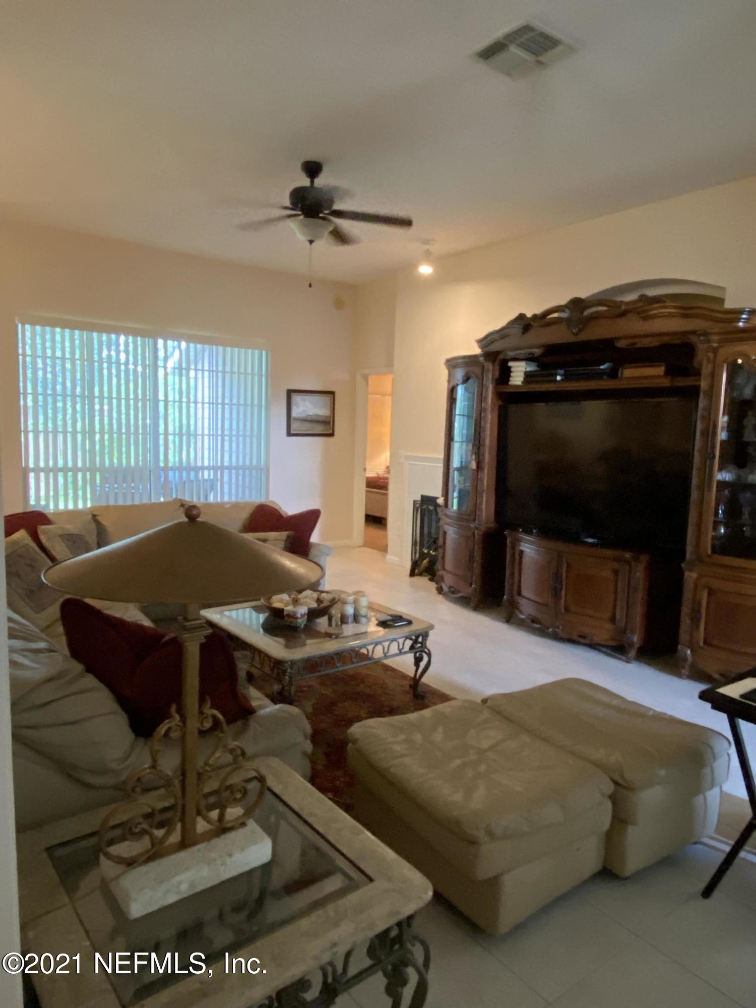 4387 Pebble Brook Drive Jacksonville, FL 32224 - Photo 10 of 30 a living room with furniture and a flat screen tv