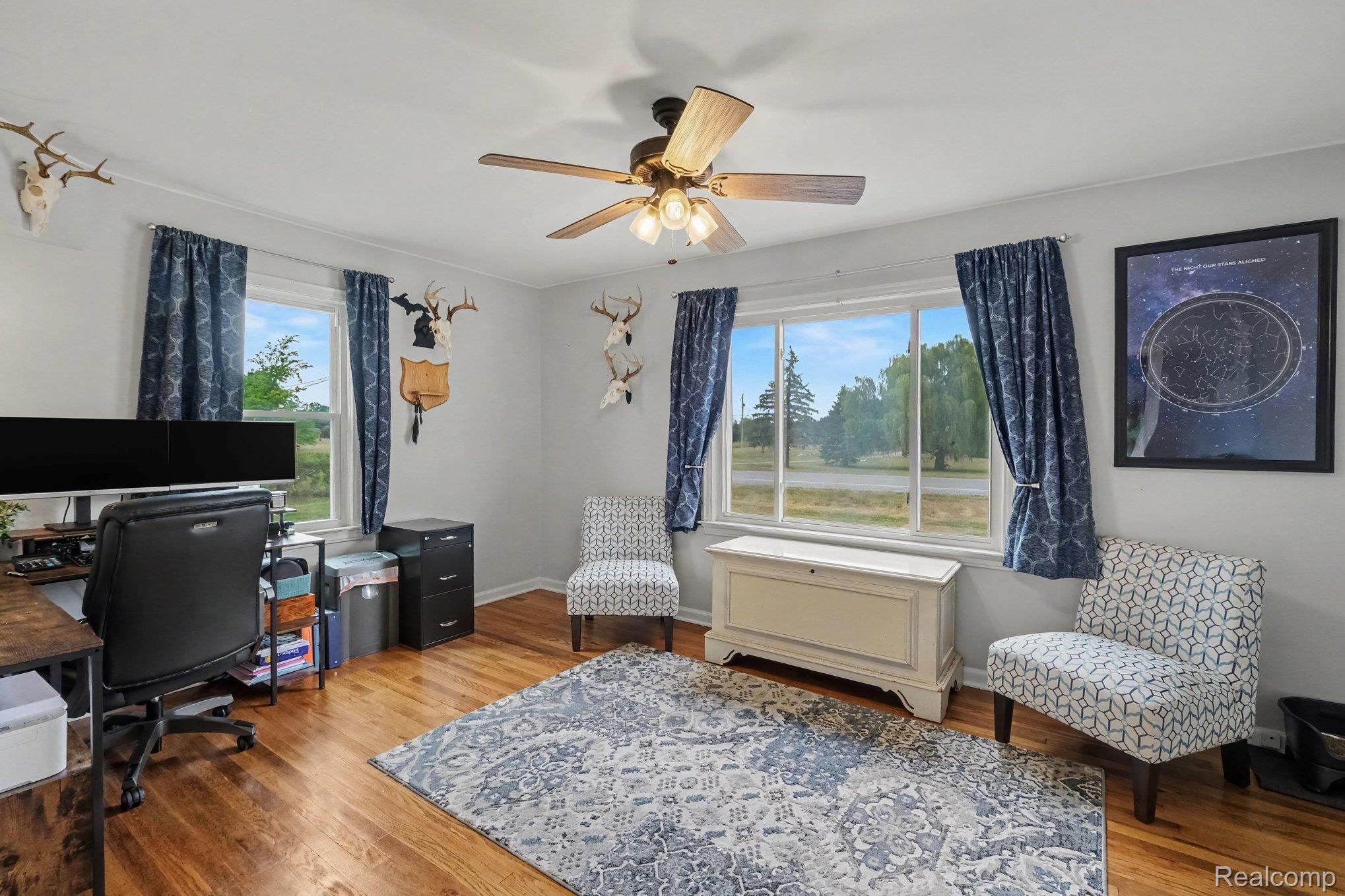 5409 Baldwin Road Swartz Creek, MI 48473 - Photo 11 of 27 Wood-finish flooring, white walls, and a ceiling fan with integrated lighting