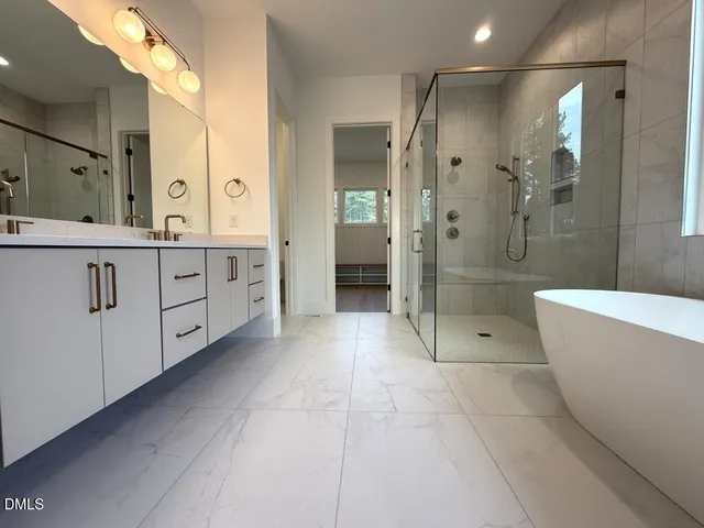 a bathroom with a double vanity sink a toilet and a mirror