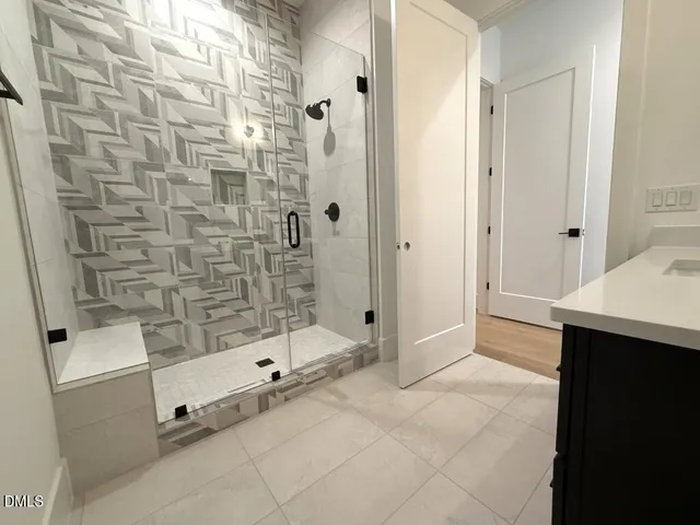 a bathroom with a granite countertop toilet sink and mirror