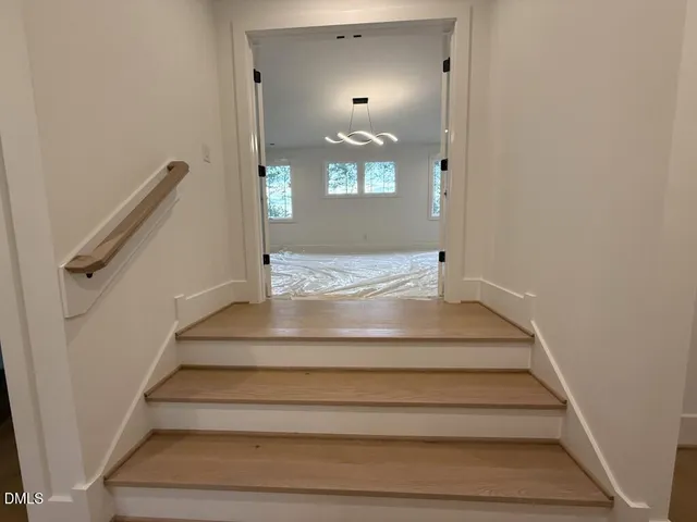 a hallway that has a bench and a table in it