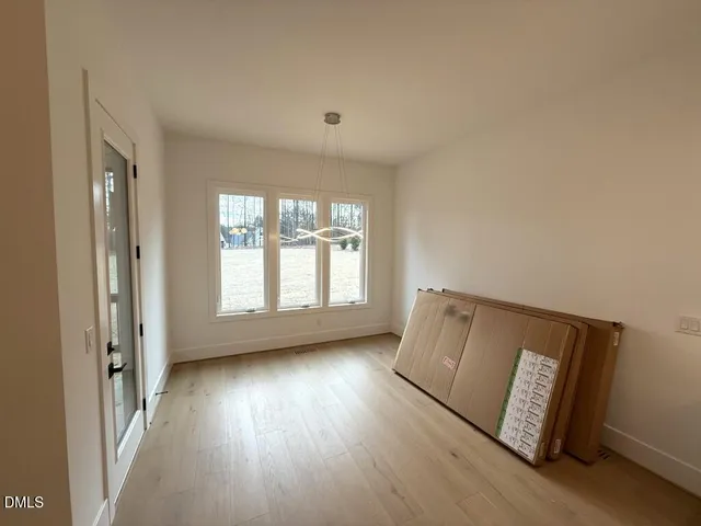 an empty room with windows and a fireplace