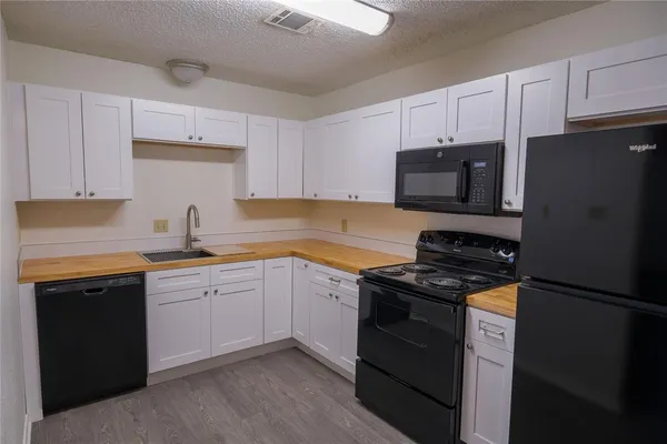 a kitchen with a sink stove and refrigerator
