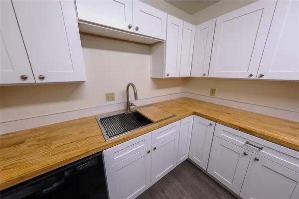 a kitchen with white cabinets and a sink
