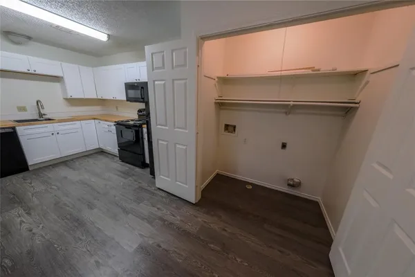 a kitchen with a refrigerator and a sink