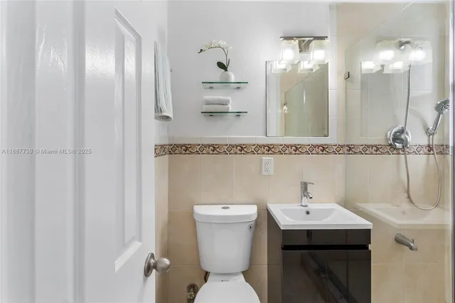 a bathroom with a sink a toilet and mirror