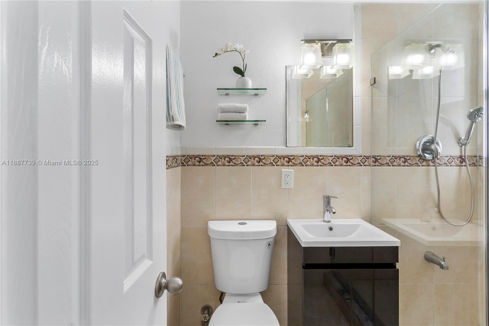 6330 Southwest 79th Street, Unit 5 South Miami, FL 33143 - Photo 15 of 19 a bathroom with a sink a toilet and mirror