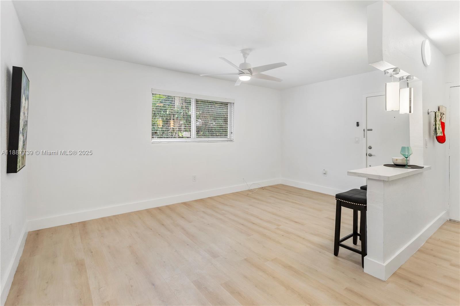 6330 Southwest 79th Street, Unit 5 South Miami, FL 33143 - Photo 17 of 19 wooden floor in an empty room with a window