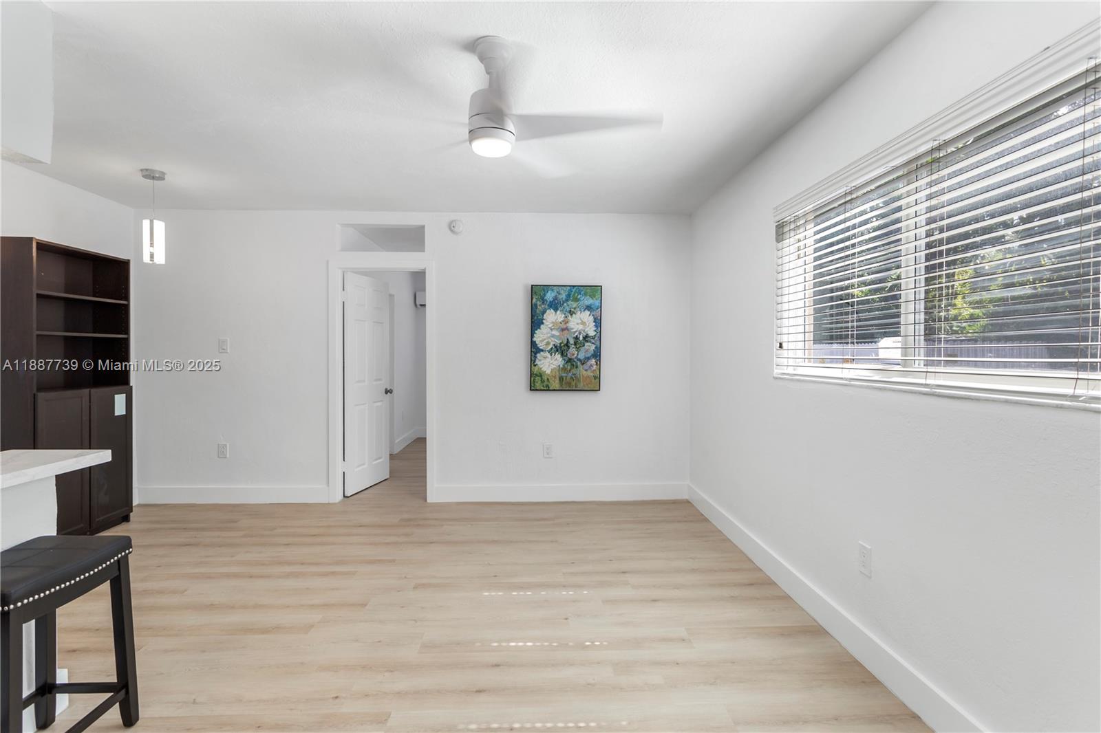 6330 Southwest 79th Street, Unit 5 South Miami, FL 33143 - Photo 2 of 19 wooden floor in an empty room with a window