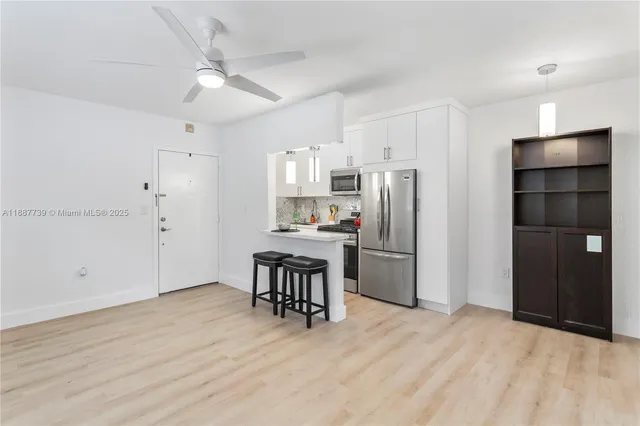 a kitchen with stainless steel appliances a refrigerator and a stove top oven