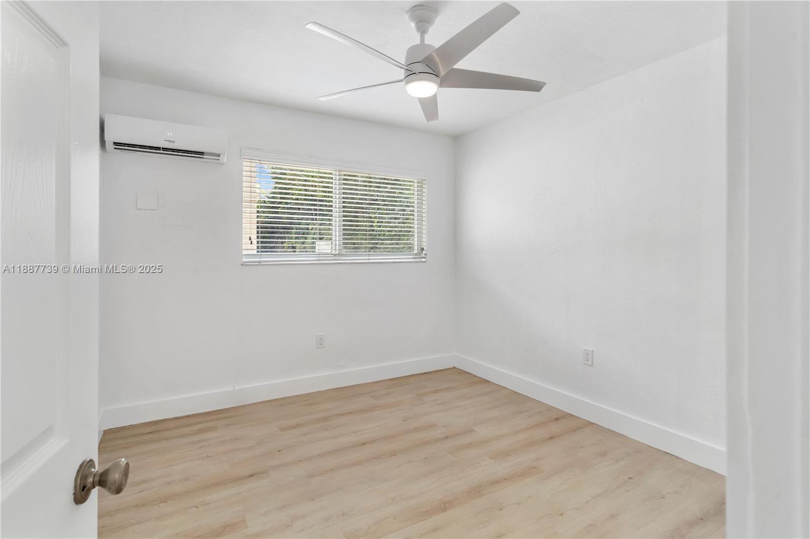 6330 Southwest 79th Street, Unit 5 South Miami, FL 33143 - Photo 9 of 19 an empty room with a window and a ceiling fan