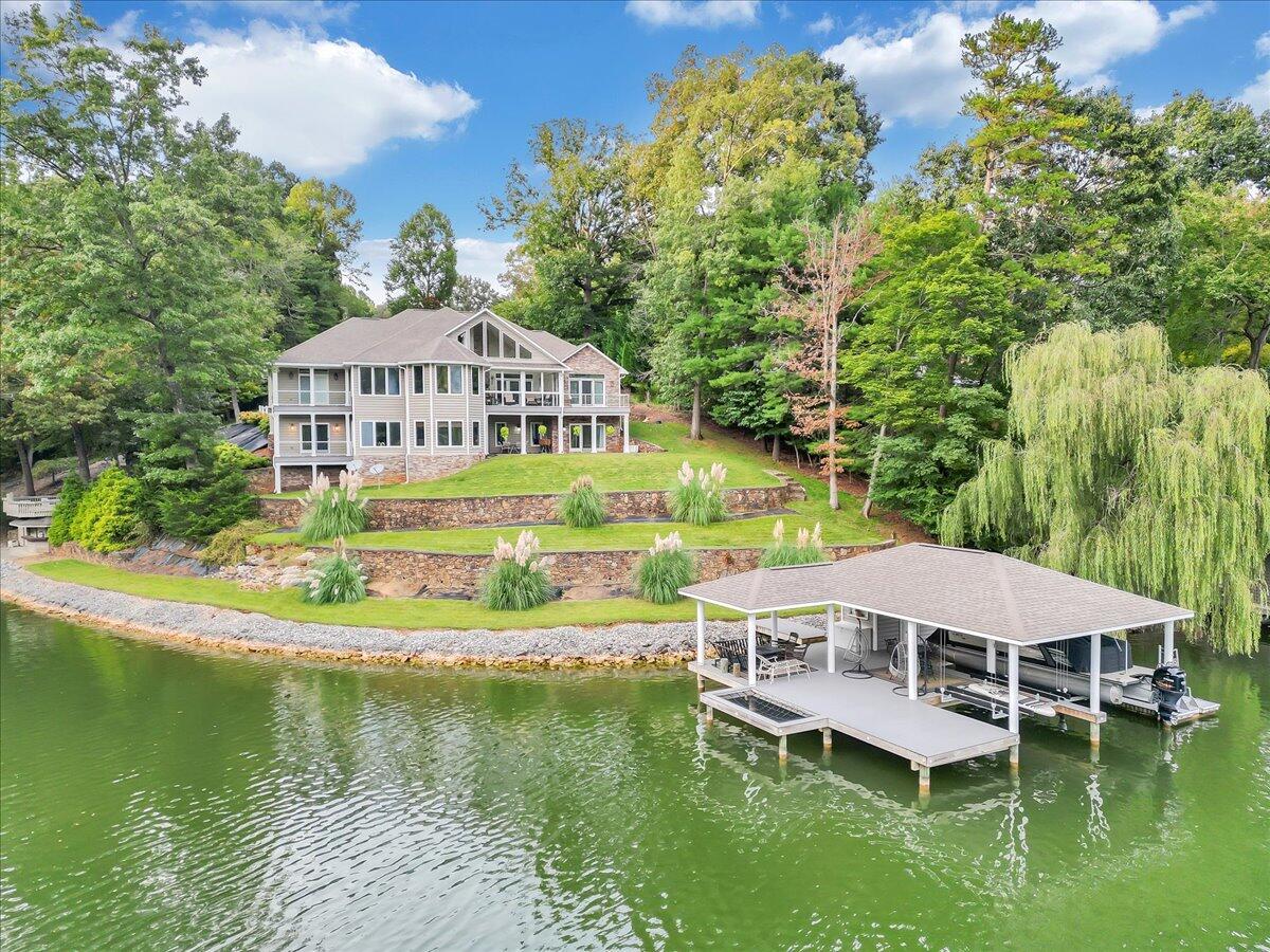 1121 Waynes Way Goodview, VA 24095 - Photo 1 of 79 a aerial view of a house with swimming pool and large trees