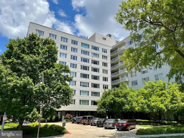 a front view of a building with trees