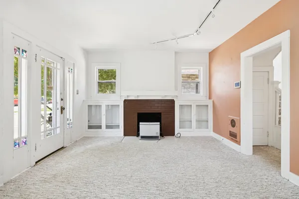 a view of a livingroom with a fireplace and window