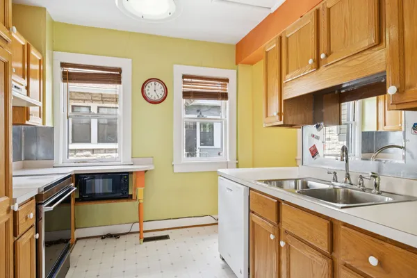 a kitchen that has a stove and a window