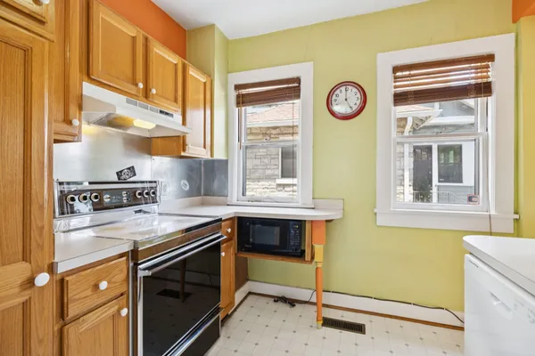 a kitchen with a stove a refrigerator and a sink