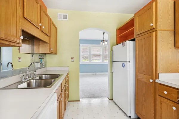 a kitchen with stainless steel appliances a sink a stove and a cabinets