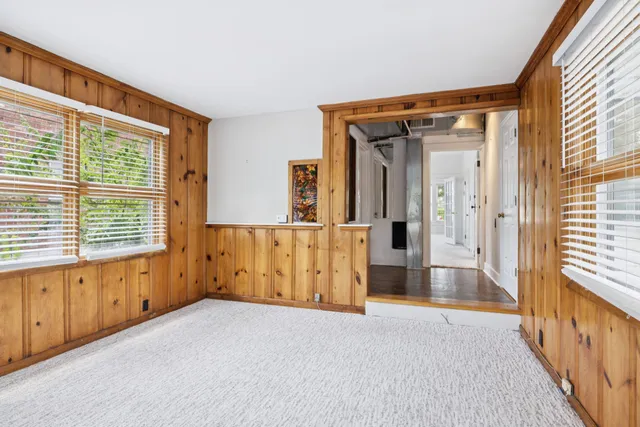 a bathroom with a granite countertop toilet sink and mirror