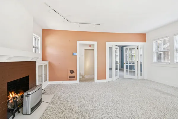 a view of an empty room with a fireplace