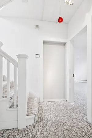 a view of staircase with white walls