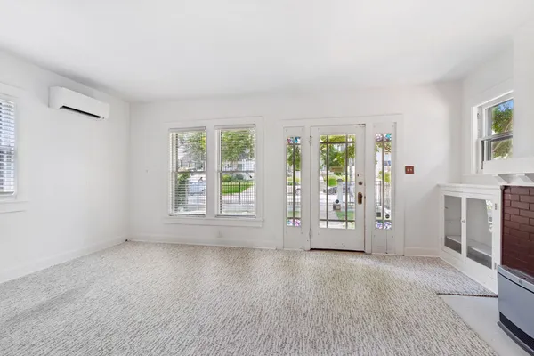 an empty room with windows and closet