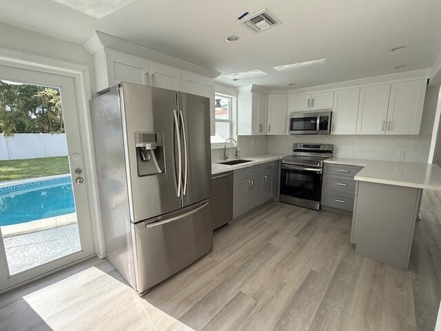 28 Southwest 9th Avenue Boca Raton, FL 33486 - Photo 3 of 16 a kitchen with stainless steel appliances granite countertop a refrigerator stove and sink