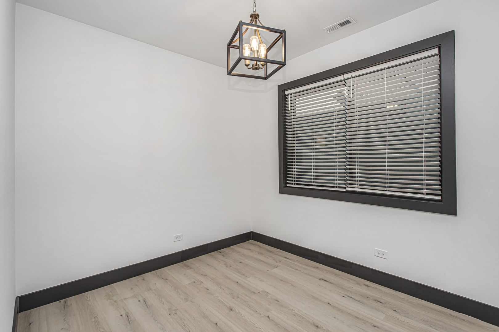 6504 South Ingleside Avenue, Unit 2 Chicago, IL 60637 - Photo 11 of 17 a view of an empty room with wooden floor and a window