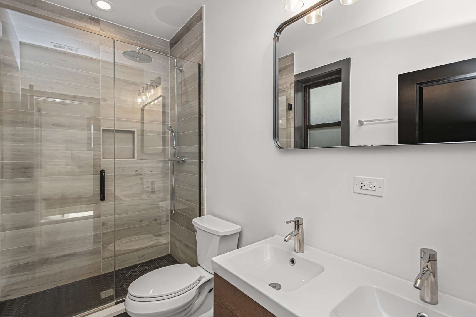 6504 South Ingleside Avenue, Unit 2 Chicago, IL 60637 - Photo 13 of 17 a bathroom with a sink toilet a mirror and shower