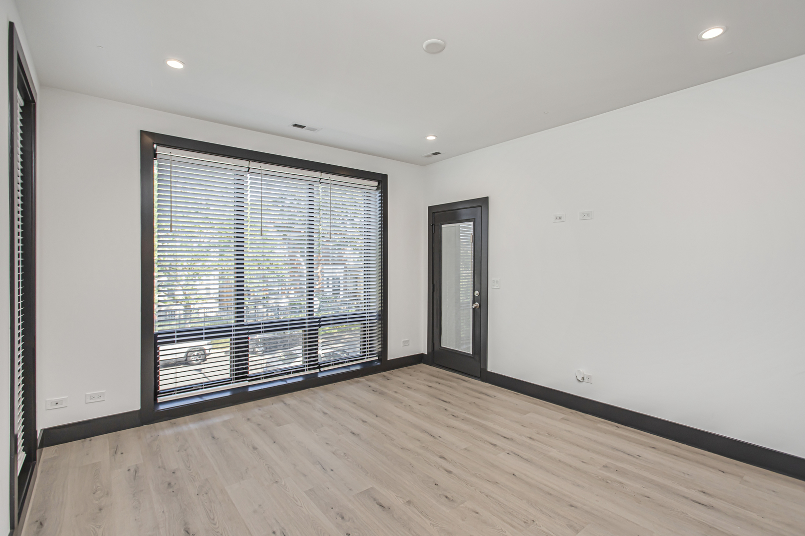 6504 South Ingleside Avenue, Unit 2 Chicago, IL 60637 - Photo 2 of 17 a view of an empty room with wooden floor and a window