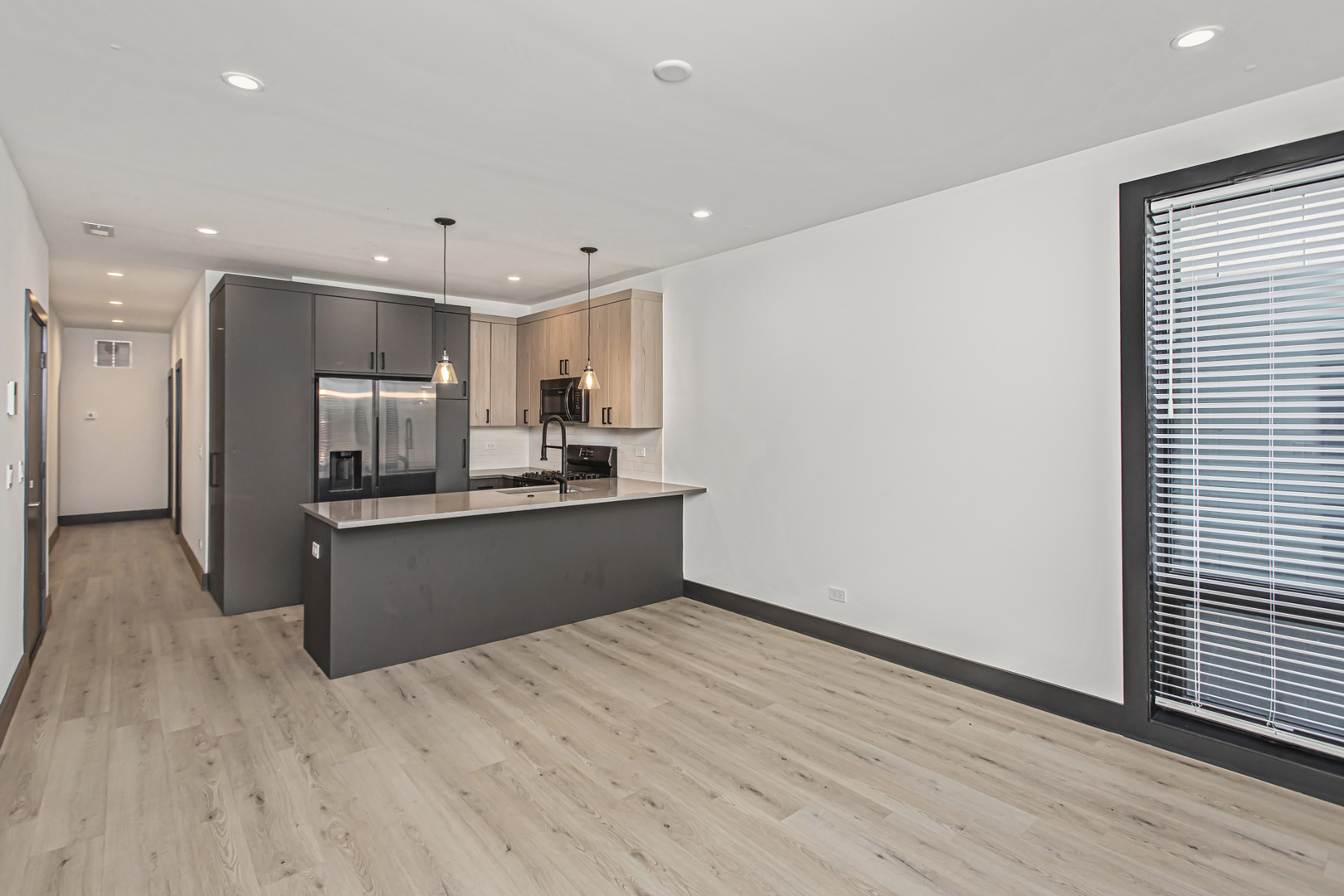 6504 South Ingleside Avenue, Unit 2 Chicago, IL 60637 - Photo 3 of 17 a kitchen with stainless steel appliances kitchen island granite countertop a refrigerator sink and cabinets