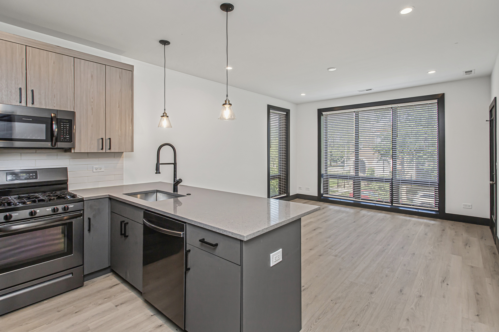 6504 South Ingleside Avenue, Unit 2 Chicago, IL 60637 - Photo 4 of 17 a kitchen with stainless steel appliances granite countertop a stove a sink and a microwave