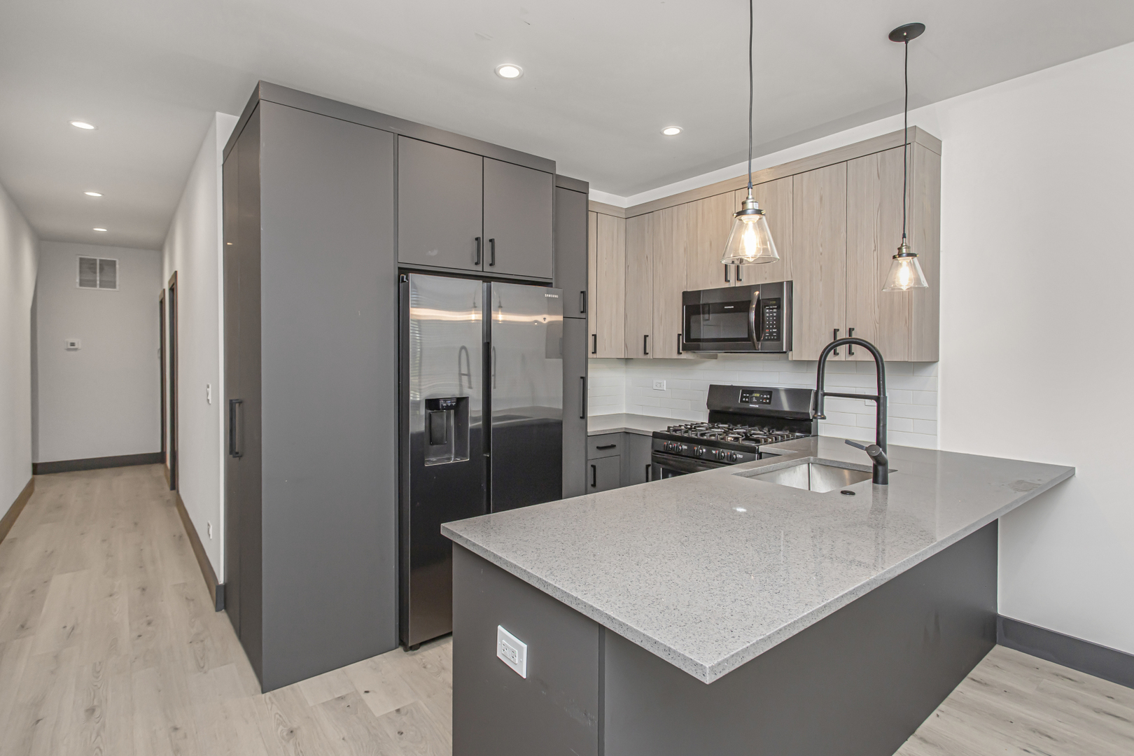 6504 South Ingleside Avenue, Unit 2 Chicago, IL 60637 - Photo 5 of 17 a kitchen with kitchen island a sink stainless steel appliances and refrigerator