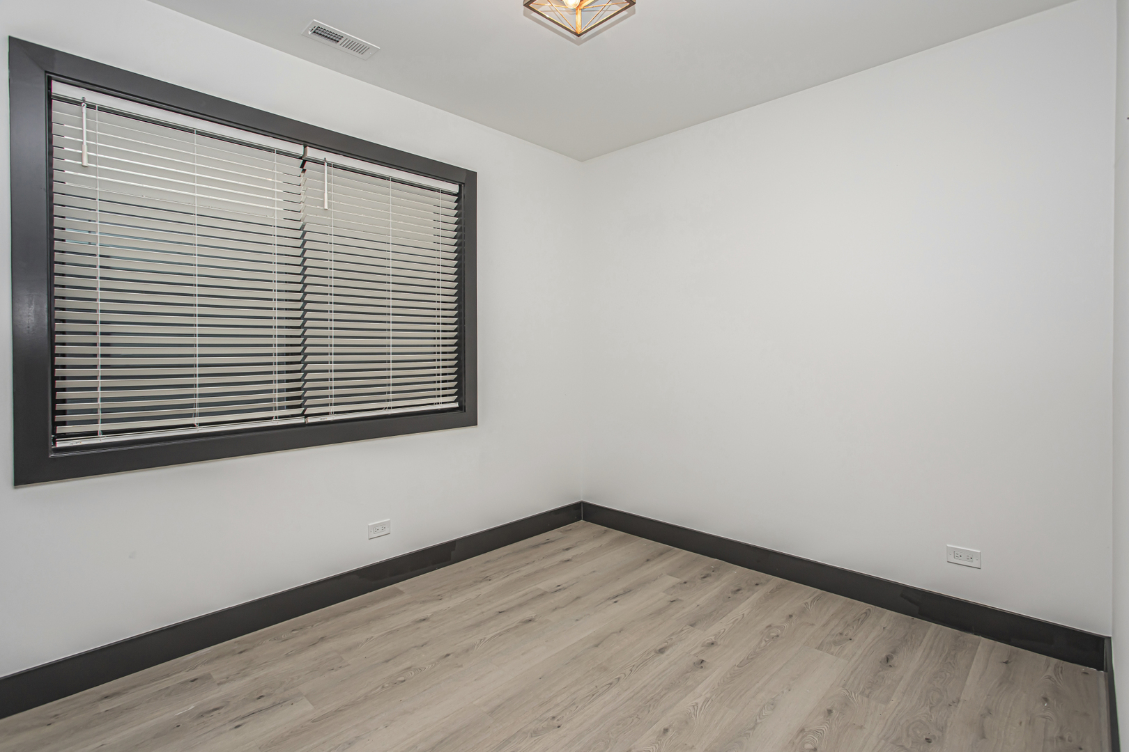 6504 South Ingleside Avenue, Unit 2 Chicago, IL 60637 - Photo 9 of 17 wooden floor in an empty room with a window