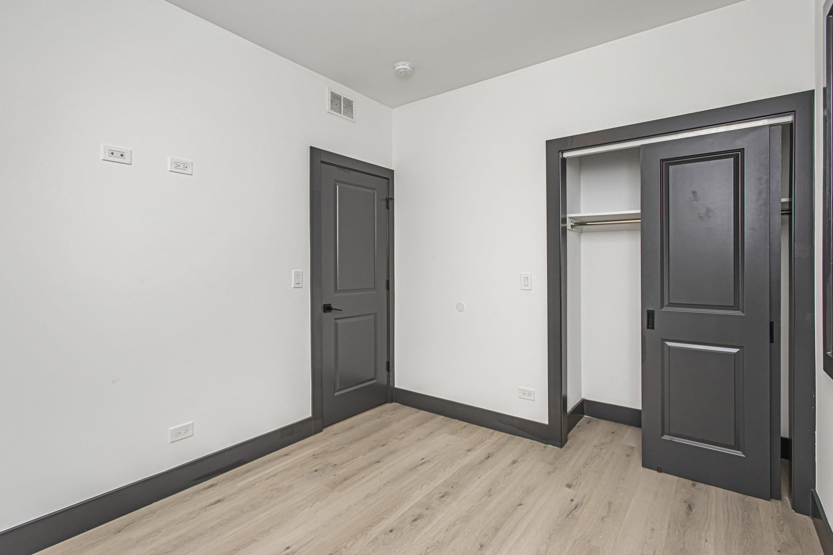 6504 South Ingleside Avenue, Unit 2 Chicago, IL 60637 - Photo 10 of 17 a view of an empty room with wooden floor and closet