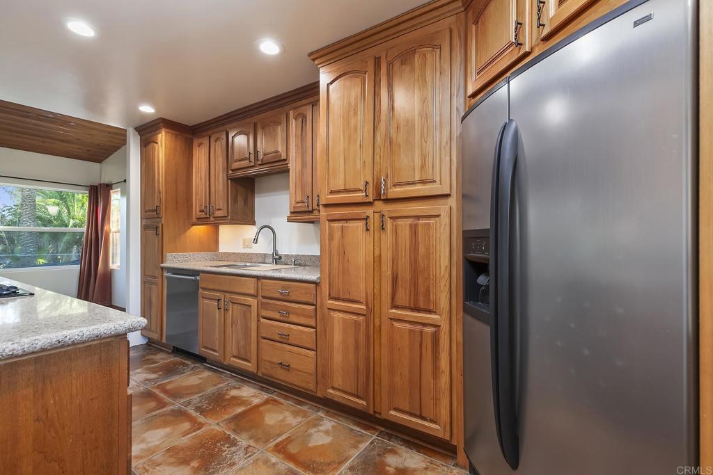10546 Valle Vista Road Lakeside, CA 92040 - Photo 12 of 66 a kitchen with granite countertop stainless steel appliances a refrigerator and cabinets