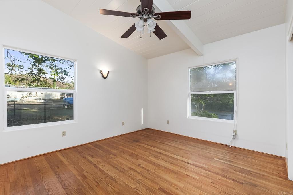 10546 Valle Vista Road Lakeside, CA 92040 - Photo 20 of 66 an empty room with wooden floor and windows