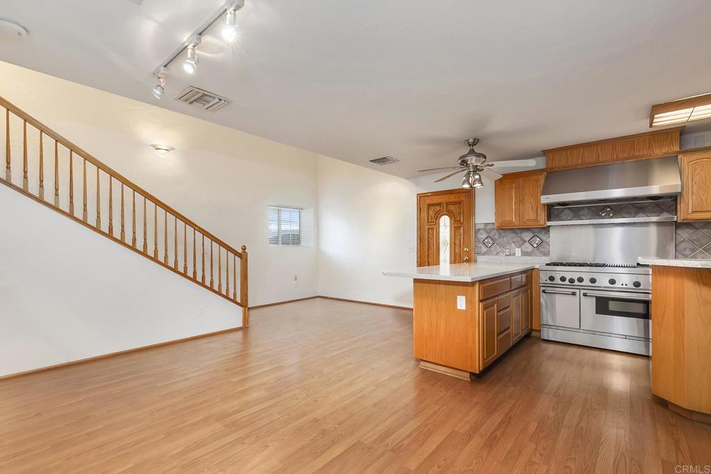 10546 Valle Vista Road Lakeside, CA 92040 - Photo 42 of 66 a kitchen with stainless steel appliances granite countertop a stove a sink and a refrigerator