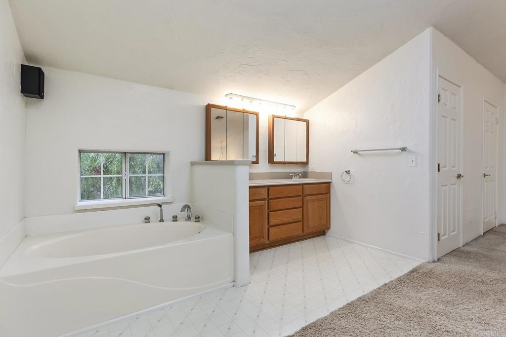 10546 Valle Vista Road Lakeside, CA 92040 - Photo 50 of 66 a spacious bathroom with a tub sink and mirror