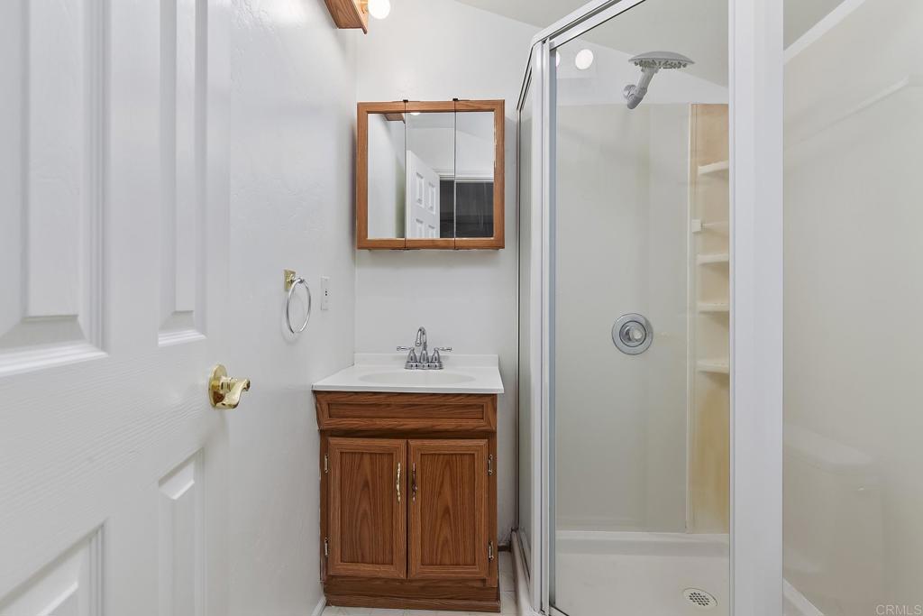10546 Valle Vista Road Lakeside, CA 92040 - Photo 54 of 66 a bathroom with a shower curtain and a sink