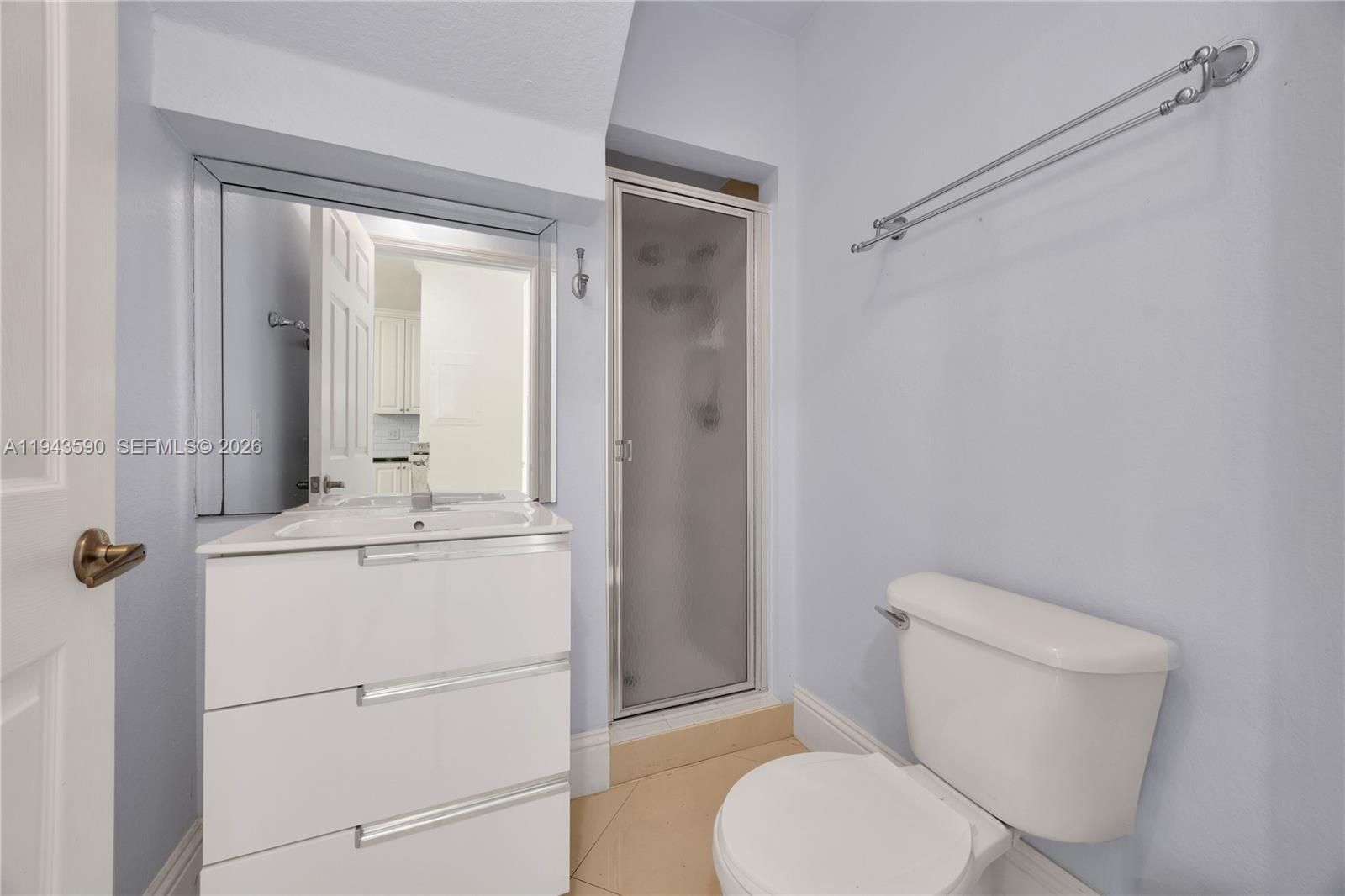 7773 Southwest 94th Lane Miami, FL 33156 - Photo 12 of 50 a bathroom with a toilet a sink and a mirror